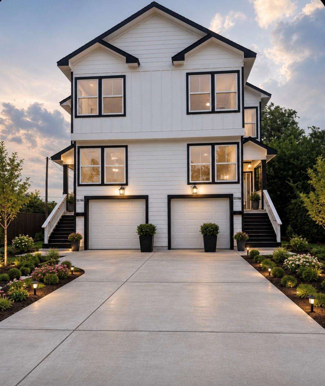 Two-story white home with black trim, front stairs and dedicated parking at dusk